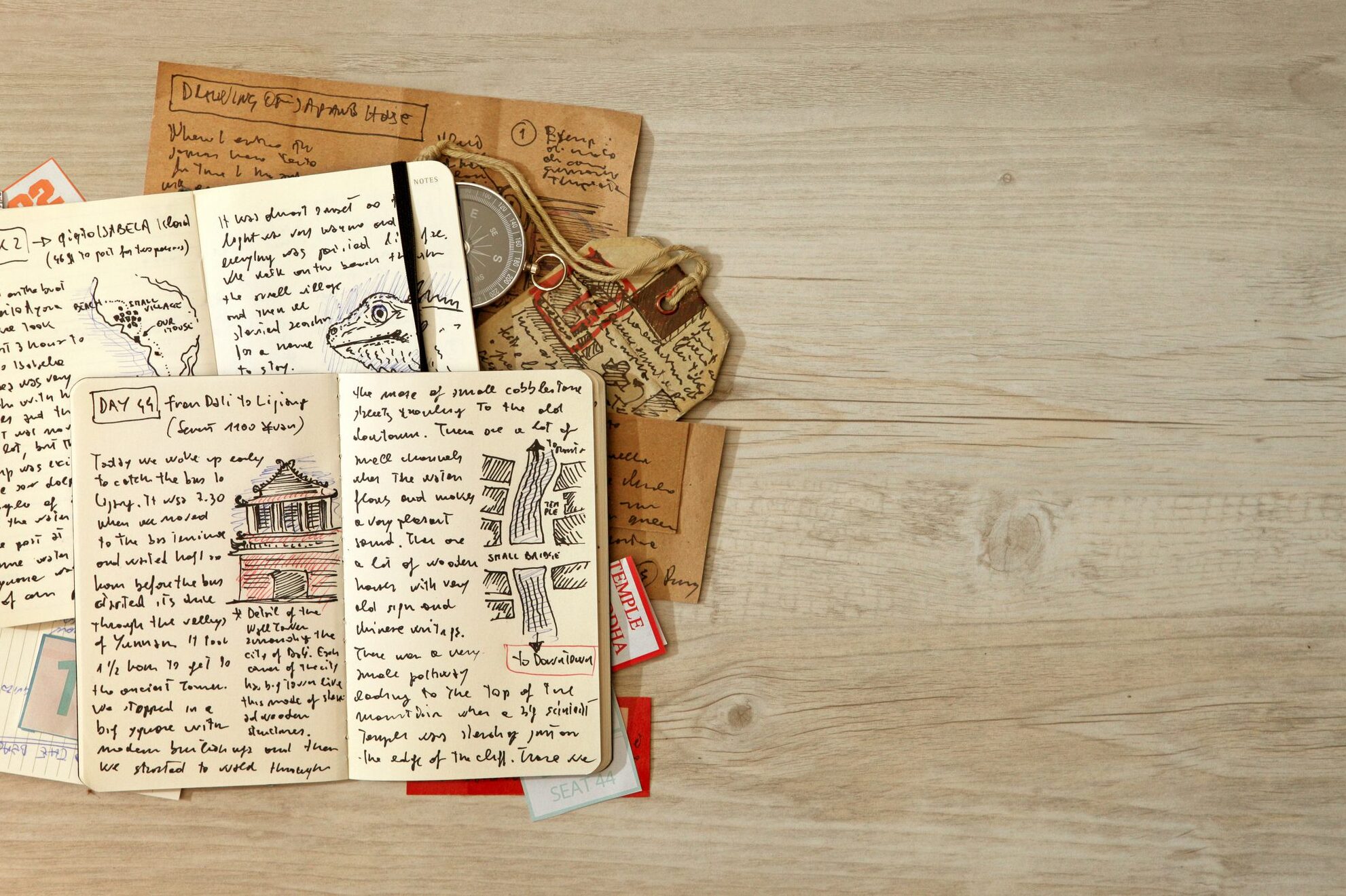 Travel journals with writing and drawings stacked on top of each other