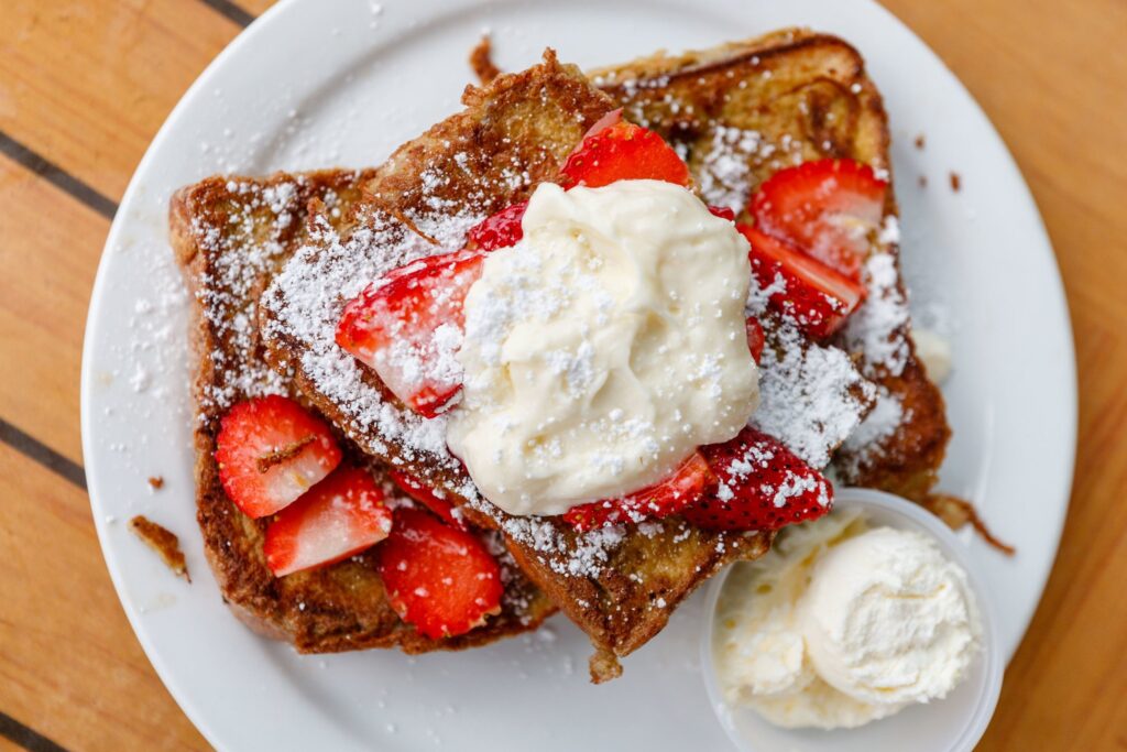 French toast with powdered sugar, whipped cream and strawberries on top from Kihei Caffe