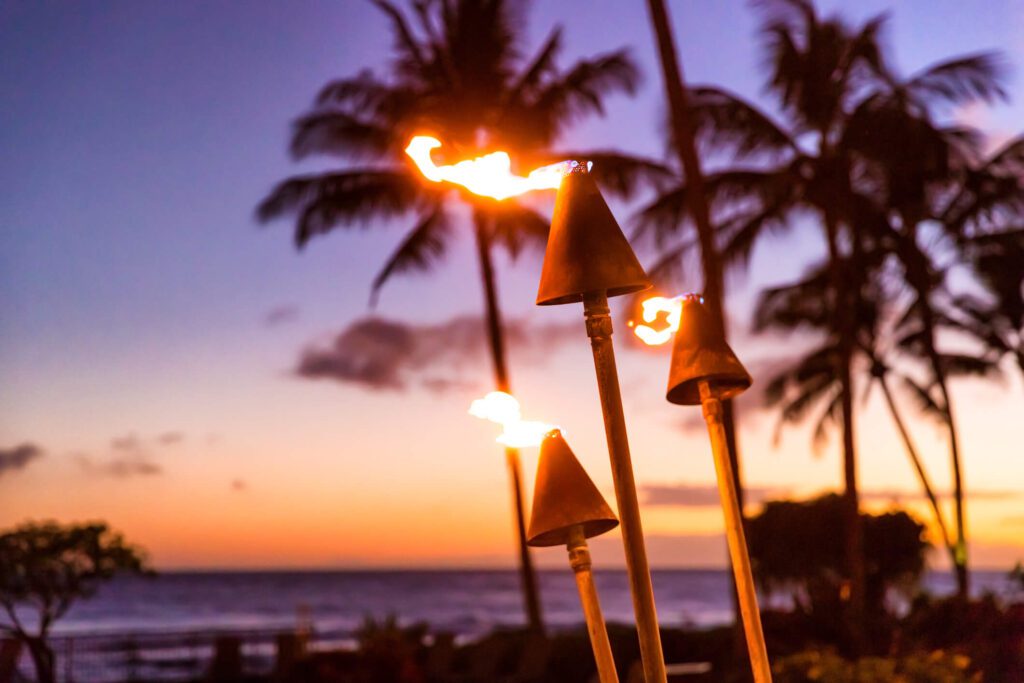 Fire torches burning at dusk at the beach or at a restaurant.