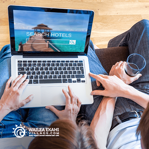 PIcture of a laptop with people searching for hotels