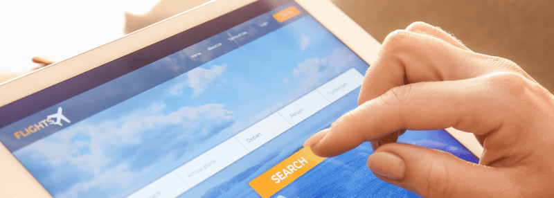 Woman clicking on Flight Search website on tablet