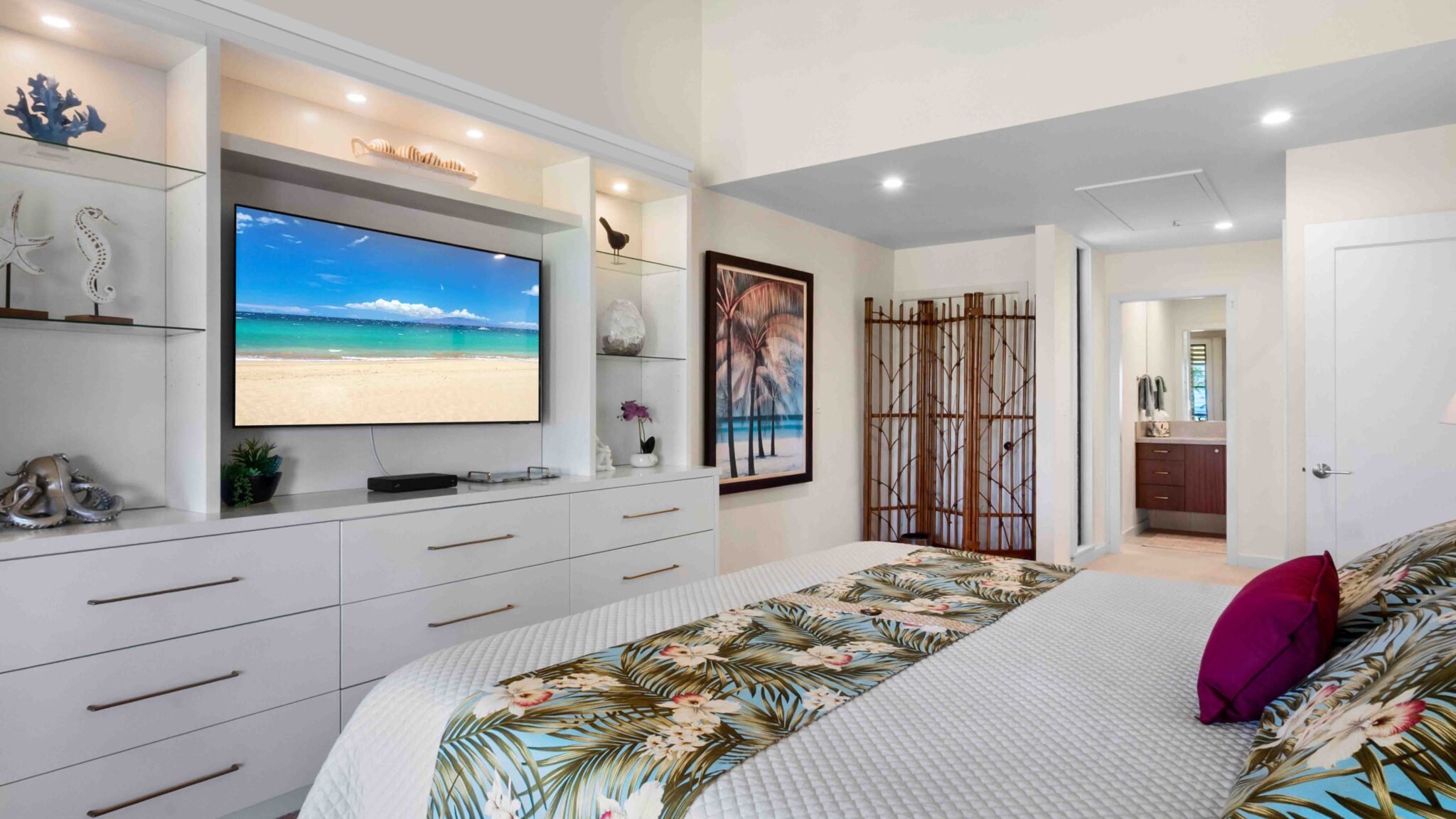 Wailea bedroom with TV and attached bathroom at rental condo