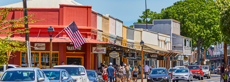 View of local shops of Maui with visitors and residents walking along the street in front of them