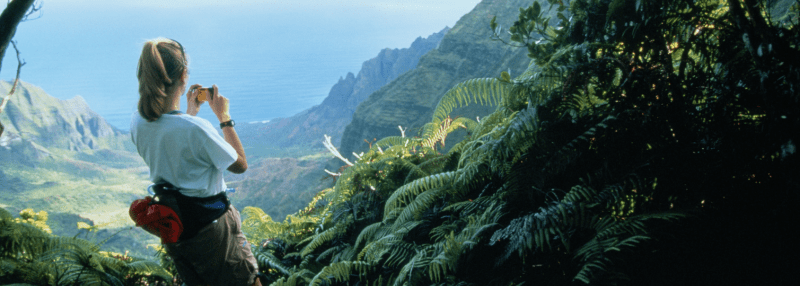 Woman taking photo of Hawaii from high above