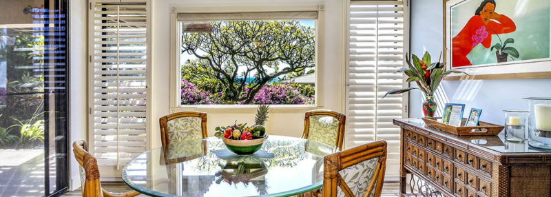 Dining table with view to beach and Wailea Ekahi Village condo flora. Ekahi 20A Rental Condo.